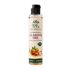 A 100ml bottle of Herby Factor Almond Oil on a clean white background. The bottle is clear plastic showing the golden oil inside, topped with a black flip-top cap.