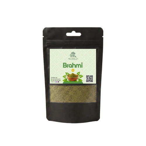 A black resealable stand-up pouch of Herby Factor Brahmi herbal powder with a light green front label and a clear window showing the green-brown powder inside, photographed on a plain white background.