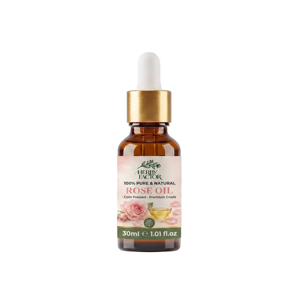 A 30ml amber glass dropper bottle of Rose Oil rosa-damascena Roghan-e-Gulab with a white dropper cap, gold collar, and a pink rose-themed label, set against a light gray background with a soft reflection.