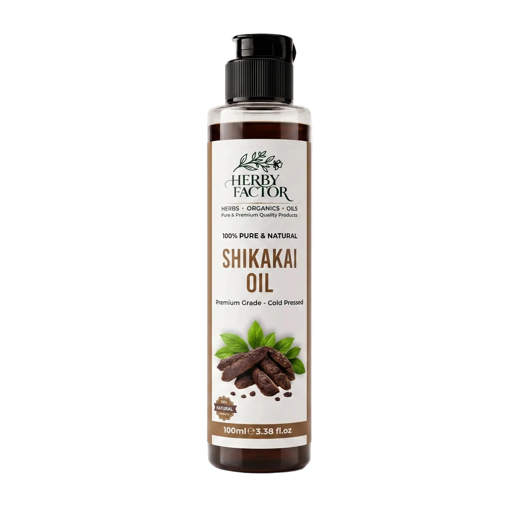 A 100ml bottle of Herby Factor Shikakai Oil, Acacia Concinna Roghan e Shikakai featuring a clear plastic bottle showing the dark brown oil inside, a black flip-top cap, and a white label with brown and green text and graphics.